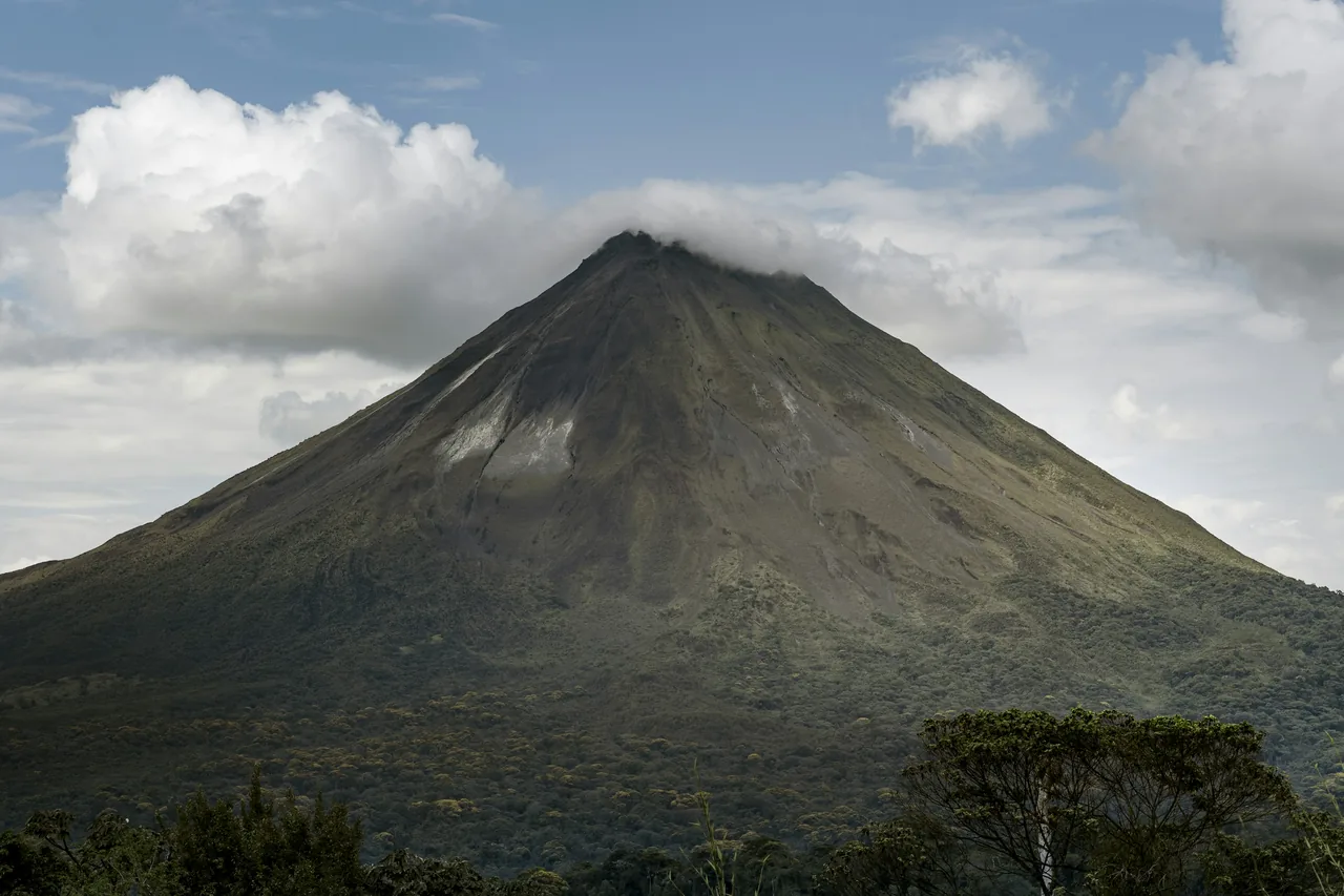 The Arenal volcano rising above the forest