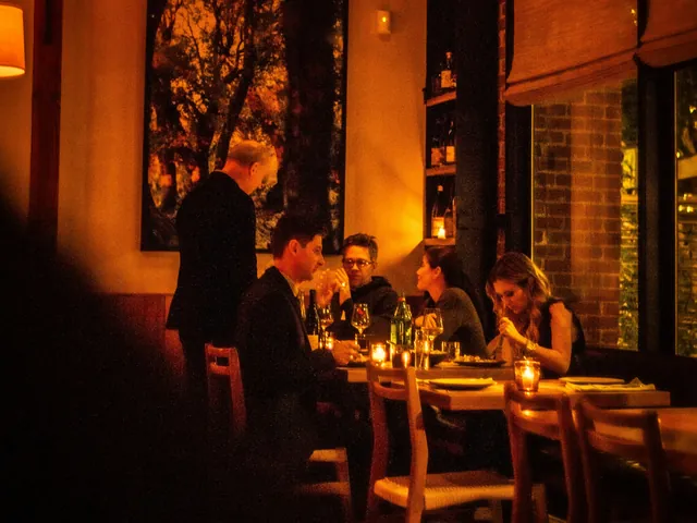 Guests dining in a warm, low lit restaurant room