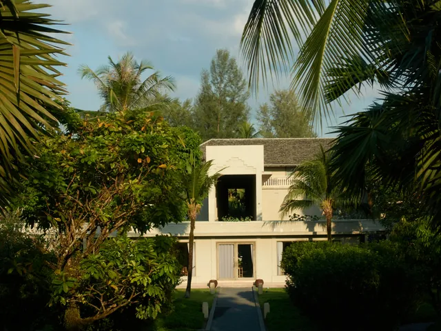 A white villa set among dense tropical planting